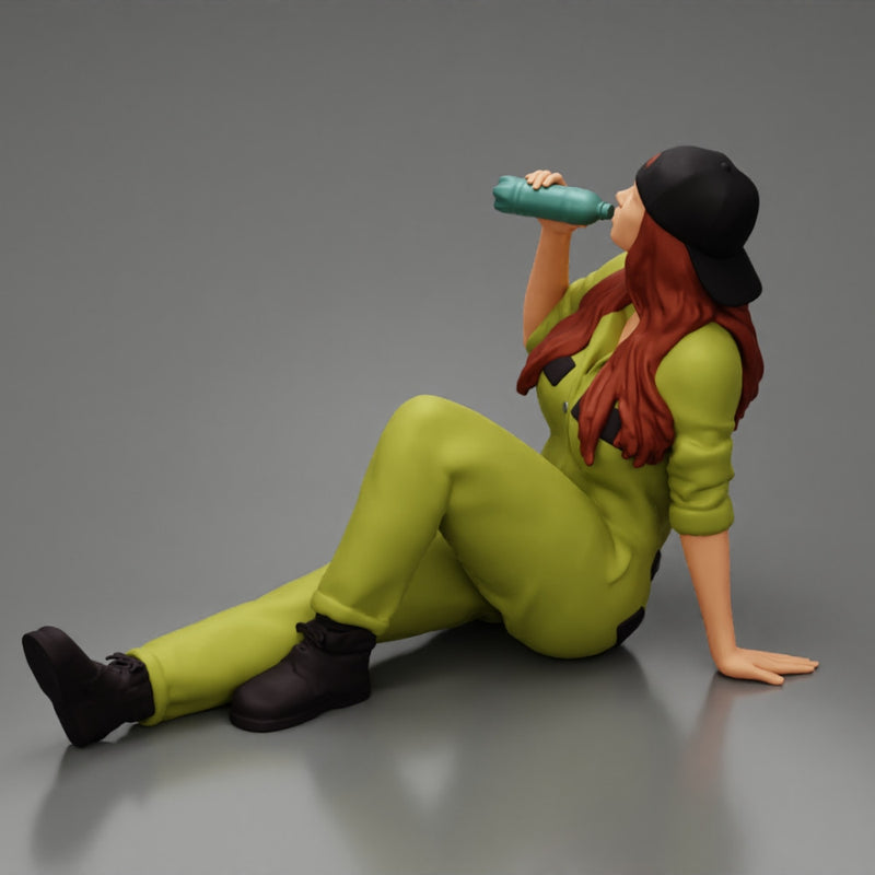 Tired woman mechanic in suit and backwards cap sitting and drinking water during from bottle - Only-Games