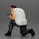 Gangster in pants sitting and holding a gun hides behind the car - Only-Games