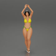 beautiful woman in a bikini with sunglasses standing with her arms raised up on the beach - Only-Games