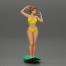 young girl posing and riding on the surfboard at the beach - Only-Games