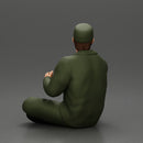 Jamie Farr sitting while eating breakfast in the MASH series - Only-Games