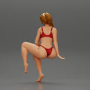 sexy girl in a bikini posing on the beach sitting at the deck chair - Only-Games