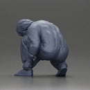 Worker injumpsuit Squatting Down, Carefully Adjusting His Pants with Focus - Only-Games