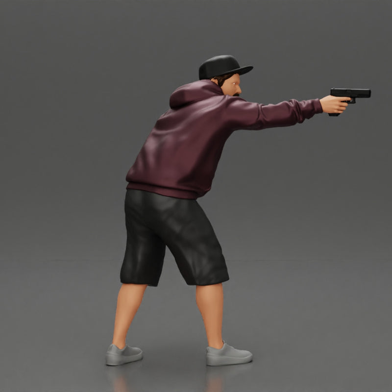 gangster man in a hoodie and cap shooting a gun behind the car