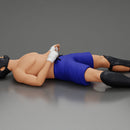 Defeated fighter lying on the floor after the battle - Only-Games
