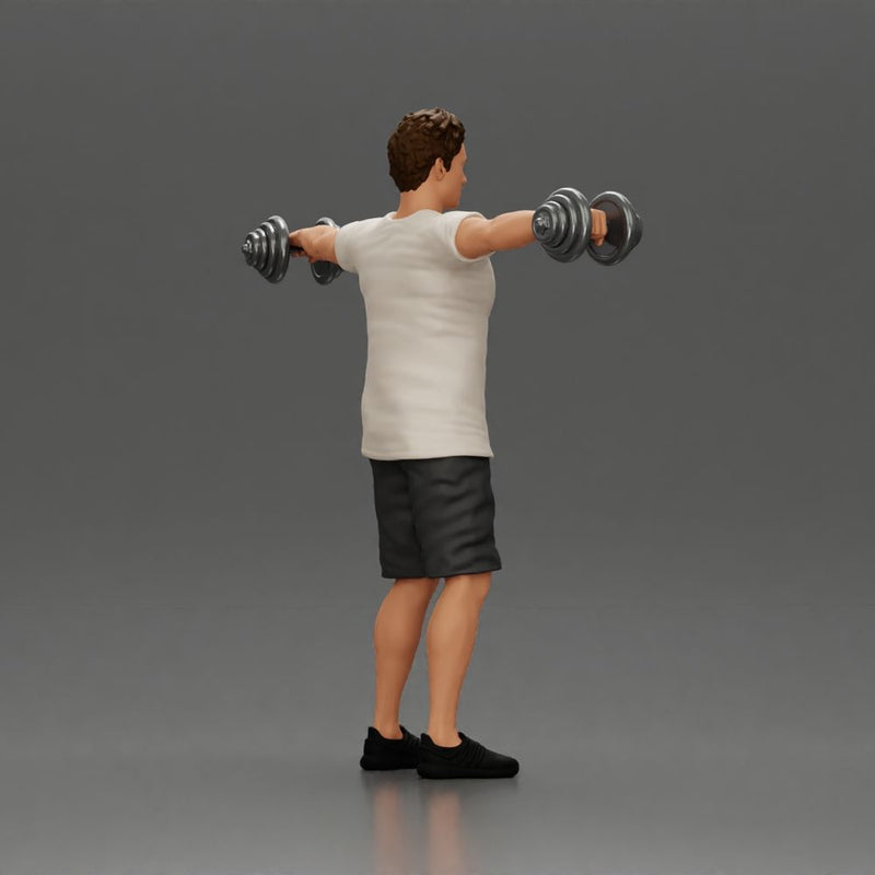 Man in the gym performing shoulder exercises with weights