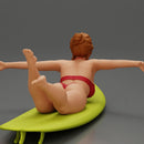 surfer girl with effortless grace, lying on her surfboard as she rides the wave - Only-Games