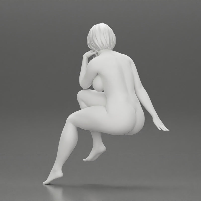 Naked woman sitting thinking