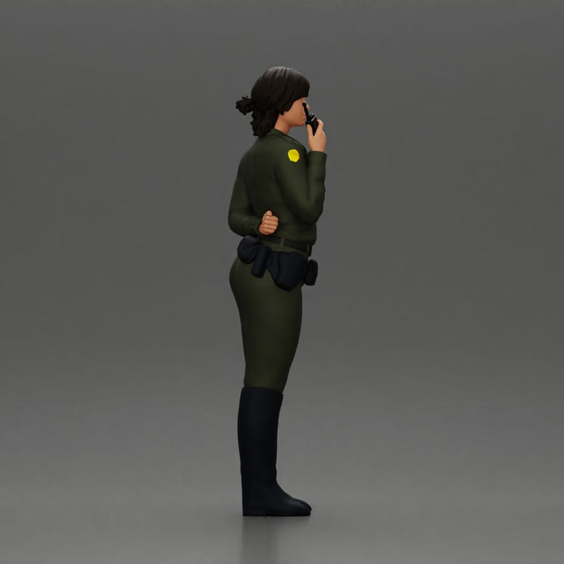 policewoman standing hand resting on her back speaking into a radio with short hair