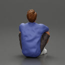 man sitting in shorts on the floor with hands on his knees - Only-Games