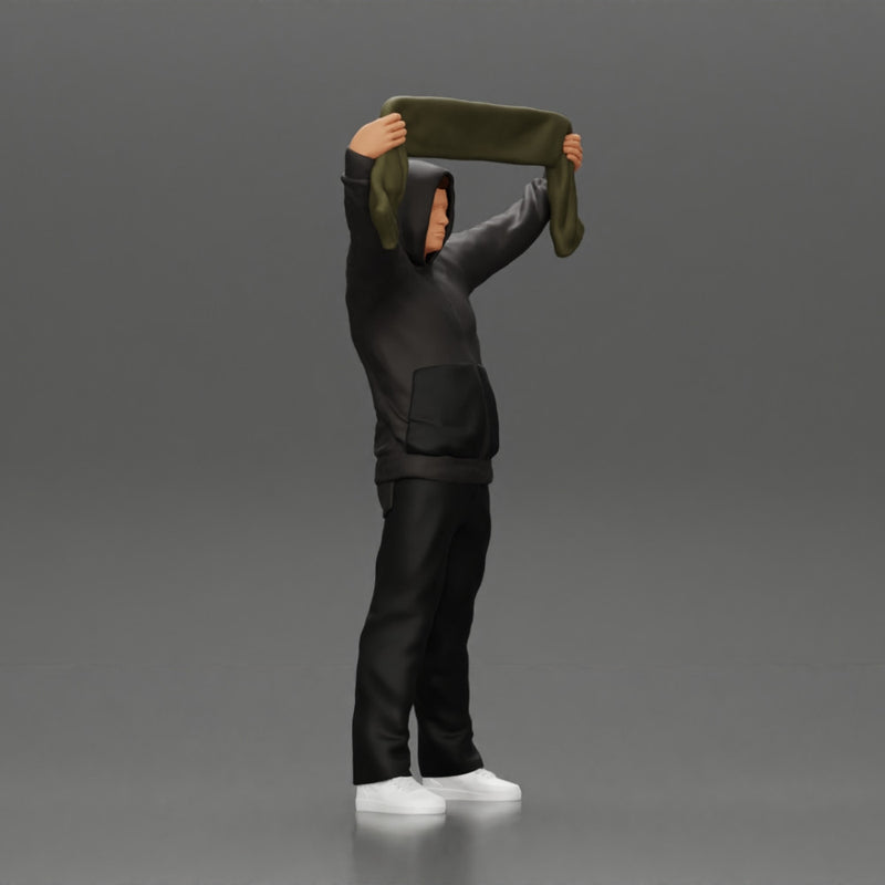 man in a hoodie supporting and holding a scarf - Only-Games