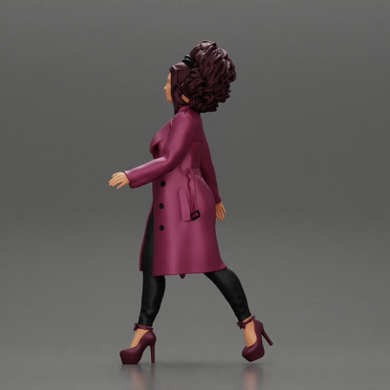 Stylish beautiful woman with curly hair in a fashion long open coat walks on the street