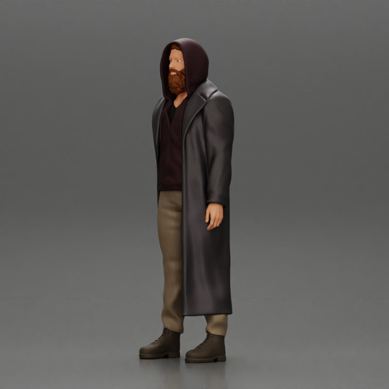 bearded man stands confidently adorned in a stylish hoodie and a flowing long coat