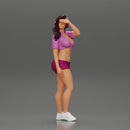 young woman in shorts and headphones shields her eyes from the sunlight - Only-Games