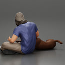 young man in a bonnet sitting crossing his legs and hugging a dog - Only-Games