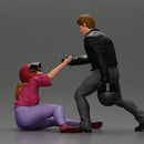 motorbike rider holding a helmet helps a biker girl, who fell off the bike, stand up - Only-Games