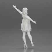 Happy Young Woman in dress and heels Standing on One Leg holding phone - Only-Games