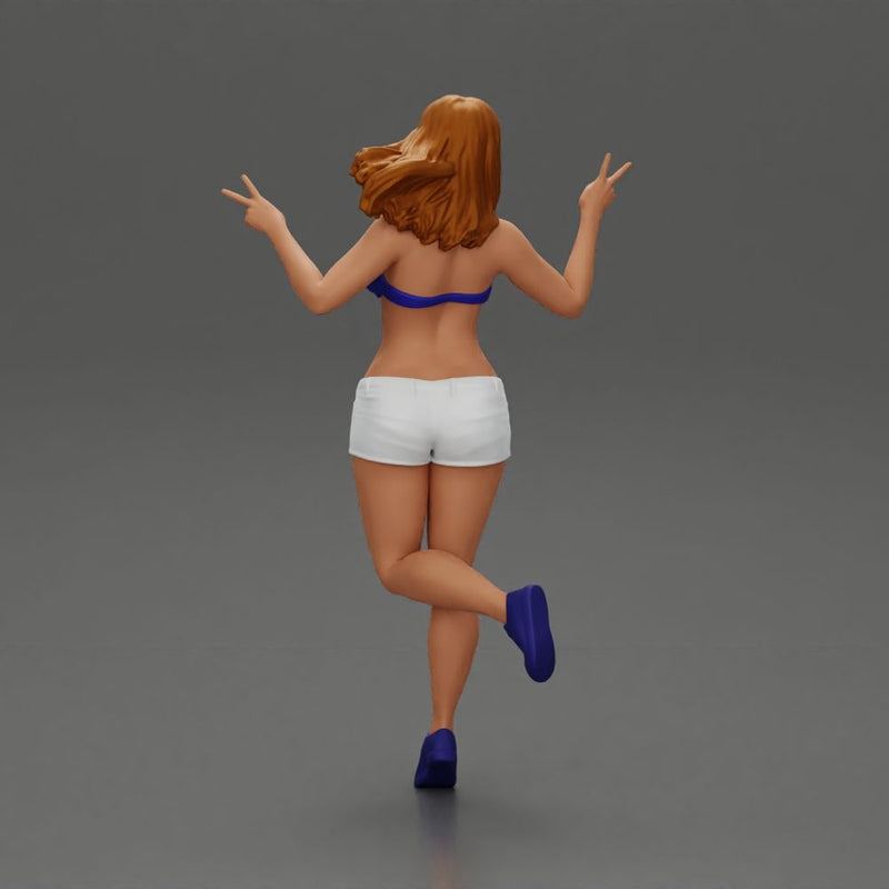 happy girl in a bra  and shorts, jumping on one leg