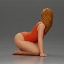 Beautiful Woman in One-Piece Bikini in a Kneeling Pin-Up Pose on the Beach - Only-Games