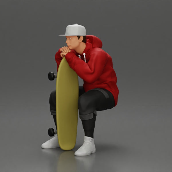 man in hoodie and cap sitting and putting his hand on the skateboard