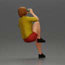 Young woman sitting on a chair hugging her pulled-up leg while drinking - Only-Games