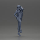 Young woman in  shirt with long hair posing with one foot resting on the motorcycle - Only-Games