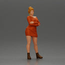 Woman in Orange Dress and Boots Stands Stylishly Confidence With Arms Crossed - Only-Games