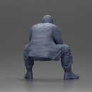 Thoughtful Man Squatting in Casual Outfit, Deep in Contemplation - Only-Games