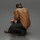 man sitting on the sidewalk and petting his dog - Only-Games