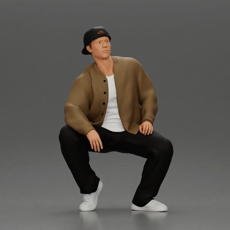 hip hop man sitting in a jacket and cap