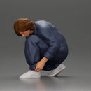 Worker injumpsuit Squatting Down, Carefully Adjusting His Pants with Focus - Only-Games