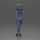 Curly-Haired Woman in Vibrant Green Outfit Striking a Pose - Only-Games