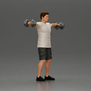 Man in the gym performing shoulder exercises with weights - Only-Games
