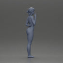 Naked woman standing hand resting on her back speaking into a radio - Only-Games