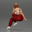 young woman sitting taking off her bib overalls - Only-Games