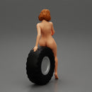 Sexy naked girl sitting on a truck tyre - Only-Games