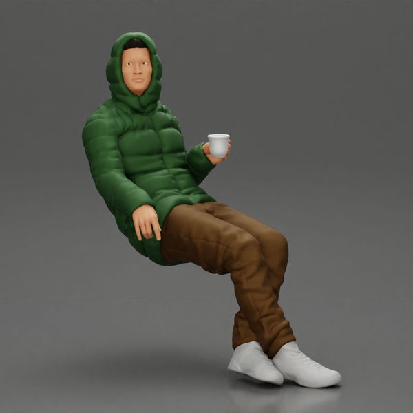 Man Sitting Wearing a Puffer Jacket, Holding a Coffee Cup