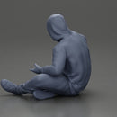 Contemplative man in hoodie sitting cross-legged, expressing curiosity thoughtfully - Only-Games