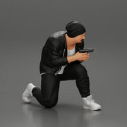 Gangster in hat and jacket sitting and holding a gun hides behind the car - Only-Games