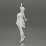 Happy Young Woman in dress and heels Standing on One Leg holding phone - Only-Games