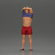 muscular man in shorts taking off his shirt to go swimming - Only-Games