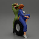 Two sexy girls in mechanic suits are sitting on a truck tire - Only-Games