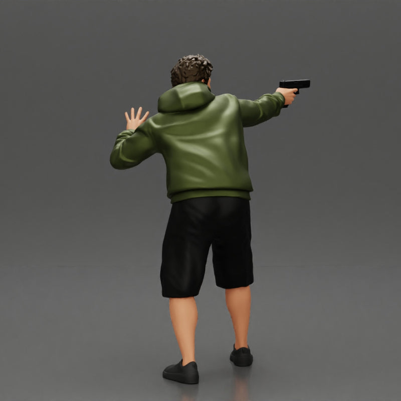 gangster man in a hoodie and shorts shooting a gun behind the car