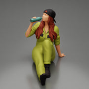 Tired woman mechanic in suit and backwards cap sitting and drinking water during from bottle - Only-Games