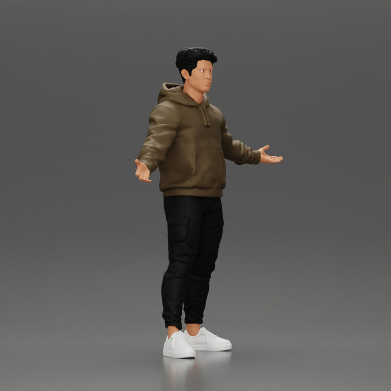 Asian Man Standing in Hoodie with Raised Hands