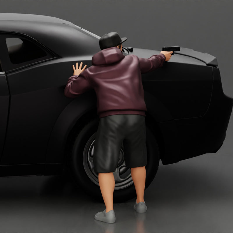 gangster man in a hoodie and cap shooting a gun behind the car