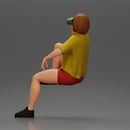 Young woman sitting on a chair hugging her pulled-up leg while drinking - Only-Games