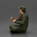 Jamie Farr sitting while eating breakfast in the MASH series - Only-Games