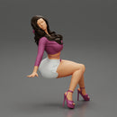 Young sexy girl in shorts with long hair is sitting with one hand in hair - Only-Games