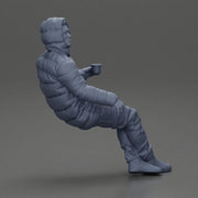 Man Sitting Wearing a Puffer Jacket, Holding a Coffee Cup - Only-Games